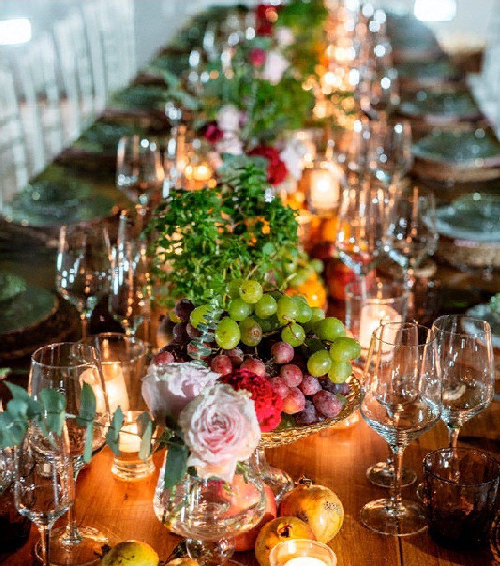 Table with candles, fruit and flowers
